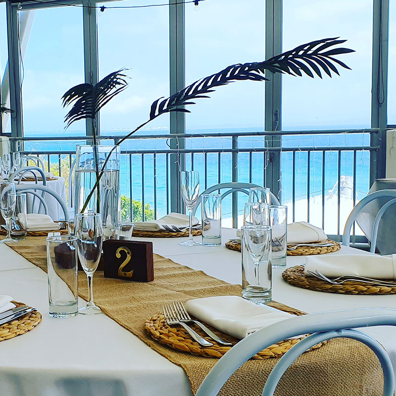 Table set up with views of the ocean.