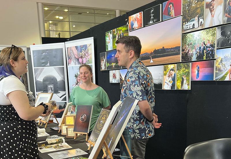 Attendee meeting trusted wedding professionals at Your Local Wedding Guide Expo.