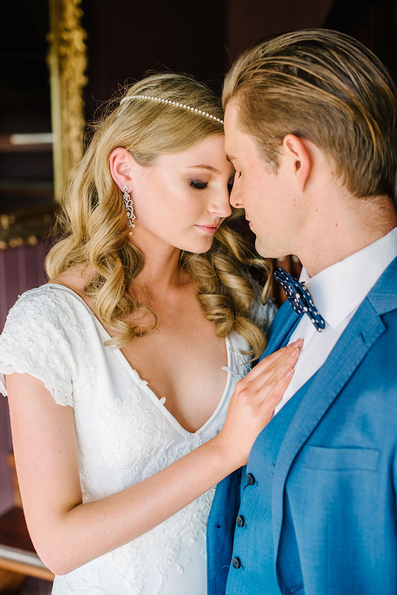 Close up of bride and groom's wedding gown and suit.