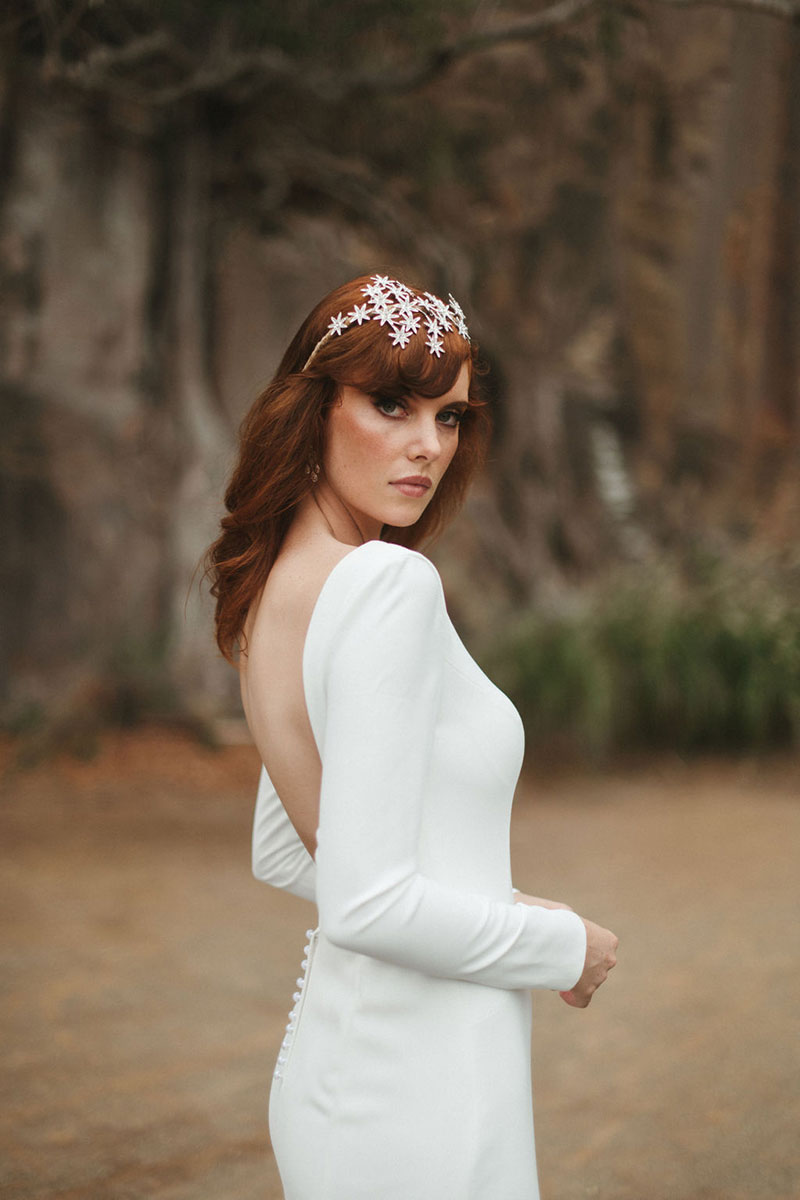 Bride wearing the sleek, low-backed wedding gown, 'Zinnia' from French by Wendy Makin.