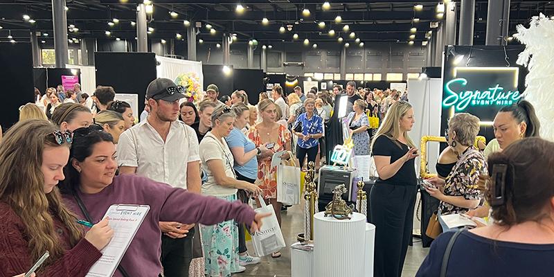 Attendees planning their weddings at Your Local Wedding Guide Brisbane Expo.