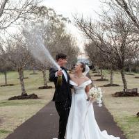 Chelea & Christian tie the knot at Preston Peak Winery Function Centre and are shown popping a celebratory bottle of sparkling.
