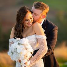 Photo of Groom hugging bride taken by Timeless Creations.