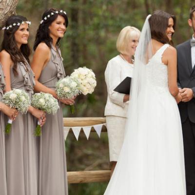  Carla & Josh saying their vows with bridesmaid's in the background