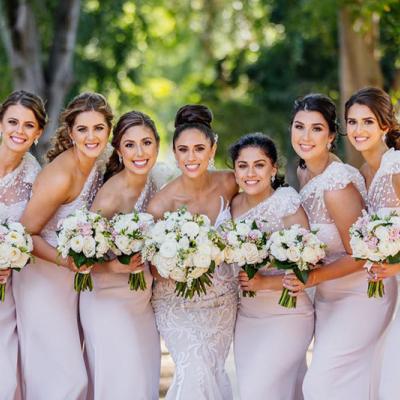 Bride and bridesmaids holding white bouquets from Brisbane Market Flowers.