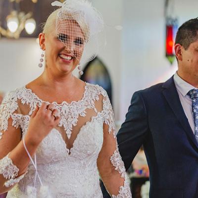 Emma and Jonathan walking down the aisle at Broadway Chapel.