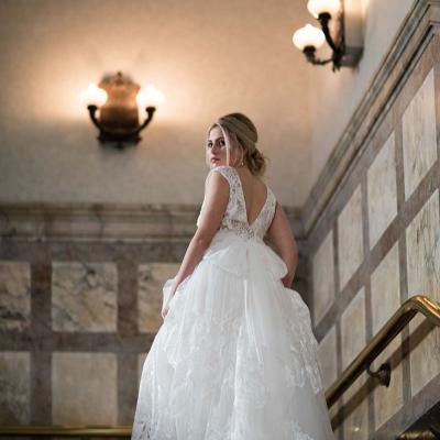 Bride walking up stairs in a traditional wedding gown by Fiorenza.