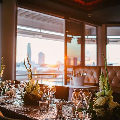 Table set for a wedding reception at Glass Dining & Lounge Bar with a view of the Gold Coast city skyline.
