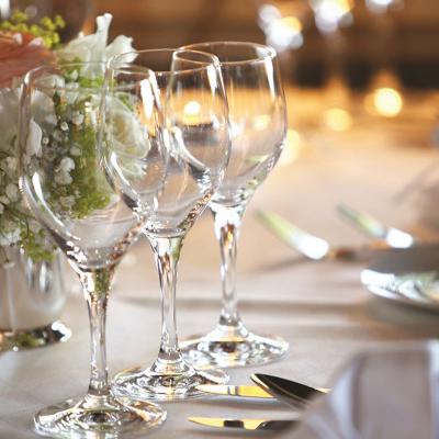 Wine glasses on a table set for a wedding reception at the Hellenic Club.
