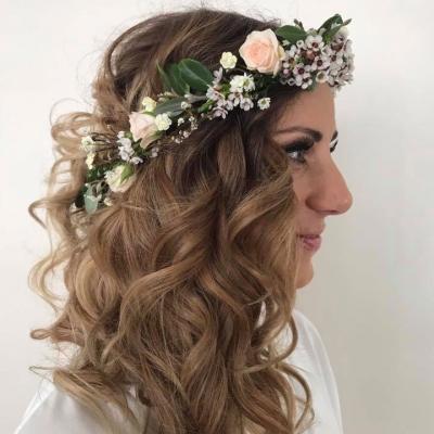 bride wearing a floral crown with long romantic curls created by Inside Hair.