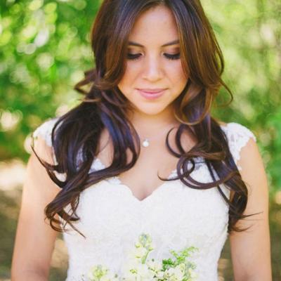 Bride holding bridal bouquet of yellow and white flowers