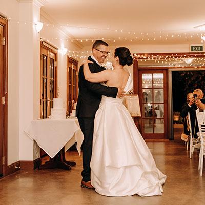 Photo taken by A Shot Above the Rest Photography of a couple dancing together at their wedding.