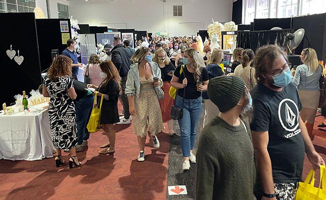 Couples browsing wedding expo booths